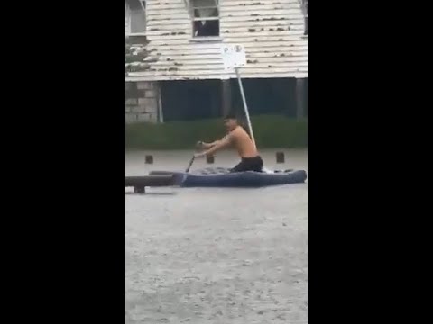 Man turns inflatable mattress into makeshift raft during Alfred flooding