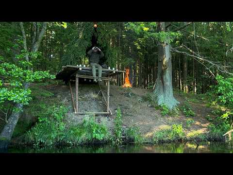 Building a bushcraft camp on a slope near a river. Cooking in nature!