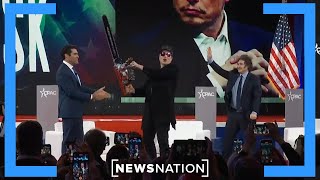 Elon Musk waves chainsaw while speaking at CPAC in DC