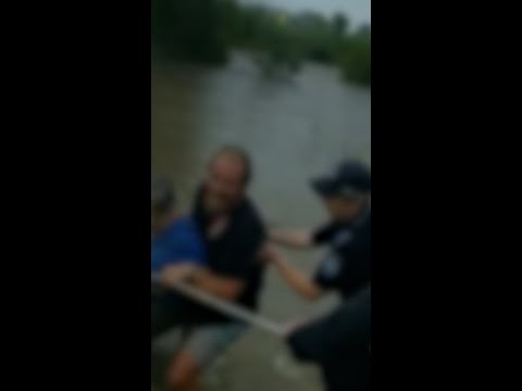 Police rescue woman trapped inside car caught in floodwaters