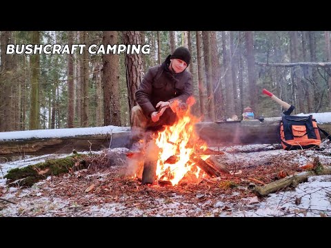 Bushcraft camping in a winter frosty forest  Lighting a fire  Cooking in the nature