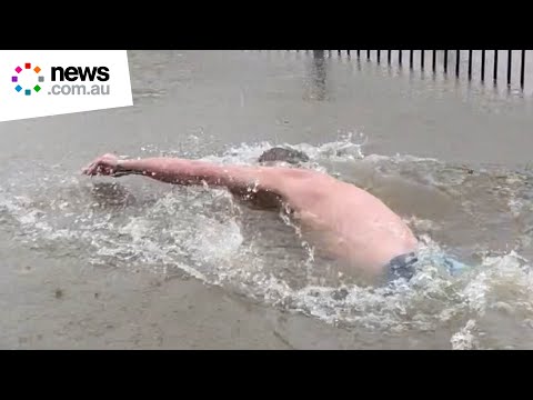 Man swims laps in backyard after cyclone floods his home