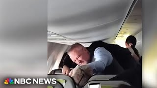 Viral video shows flight attendant punching man attacking female passenger